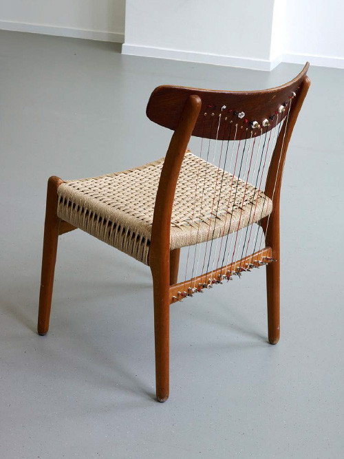 
     <i>Chair Harp (from the series Music Room, Brussels)</i>, 
     2015<br />
     Scandinavian Designer chair from the 70s, teakwood, straw, harp strings, 
      75 x 52 x 50 cm<br />
     