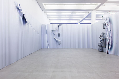
     <i>Sammelstelle</i>, 
     1992<br />
     corrugated iron, steel, aluminium, 
      dimensions variable<br />
     Installation view Kunstverein Hamburg, Germany, 2013, Photo: Kunstverein Hamburg / Fred Dott