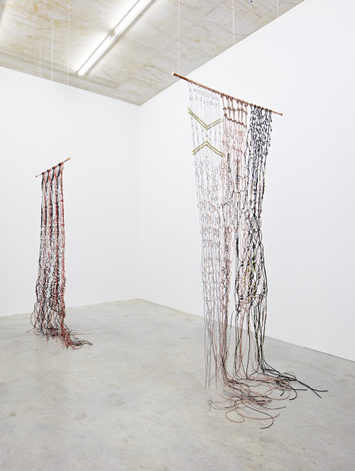 
     <i>Makramé, current flow 1 and 2</i>, 
     2017<br />
     power cable, loudspeaker cable, Lan cable, Telephone cable, copper, zinc, PVC, 
     <br />
     Installation view, Sammlung Philara, Düsseldorf, Germany, 2018
